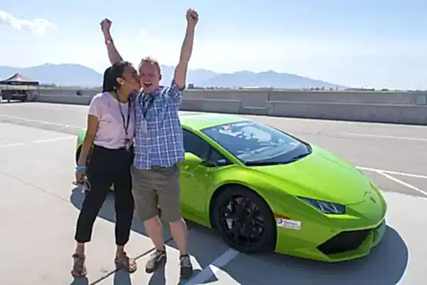 man in front of supercar