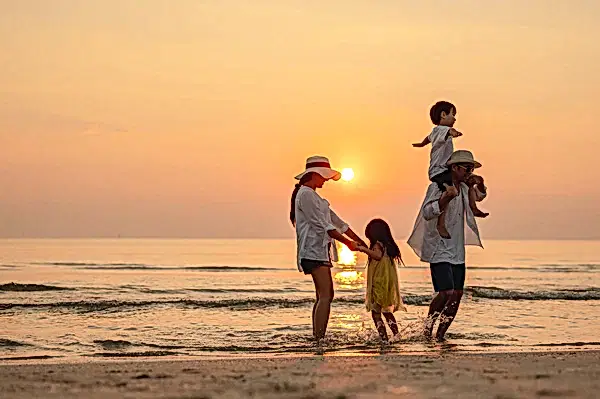 family on the beach at sunset