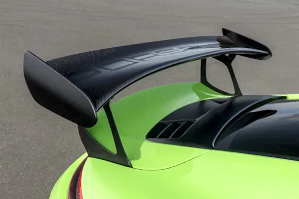 green porsche driving fast